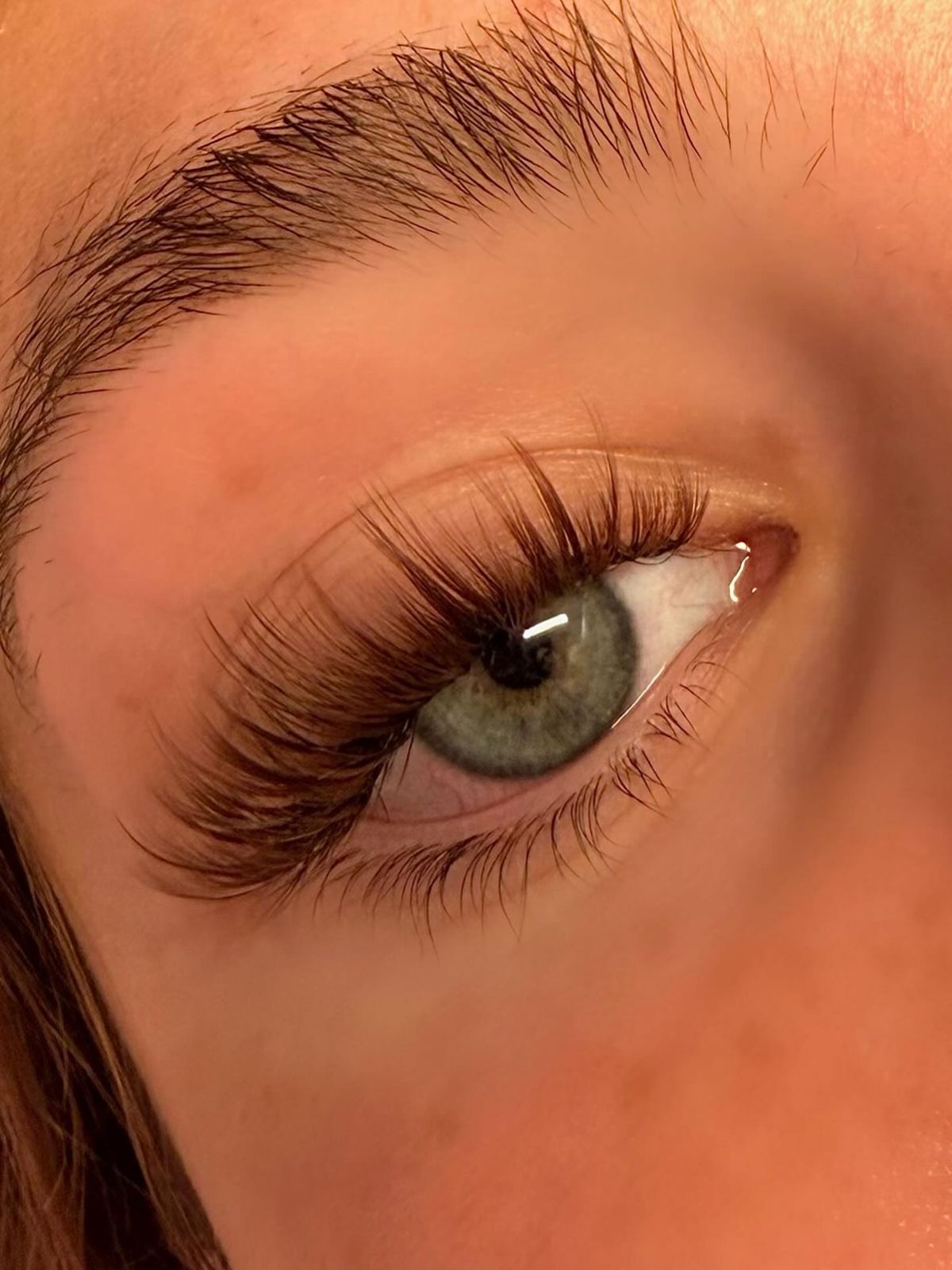 Soft brown classic-style lashes on a green eye